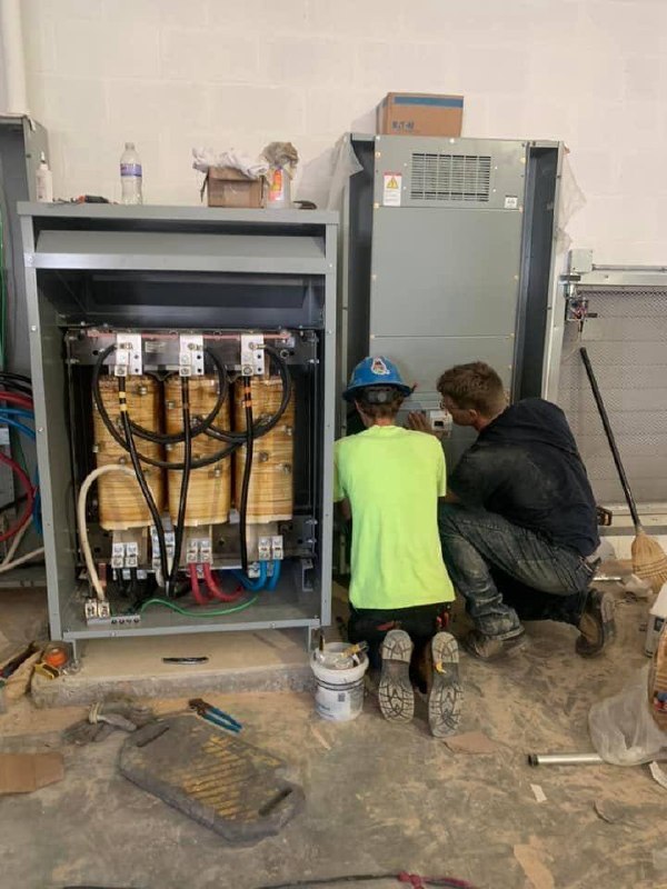 Crew installing commercial switchgear
